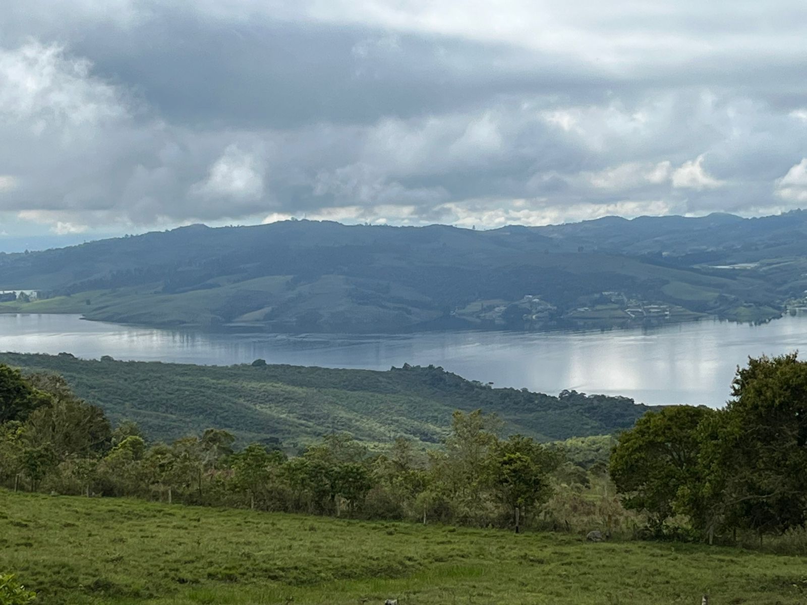 The lake under gray clouds, seen from the pasture