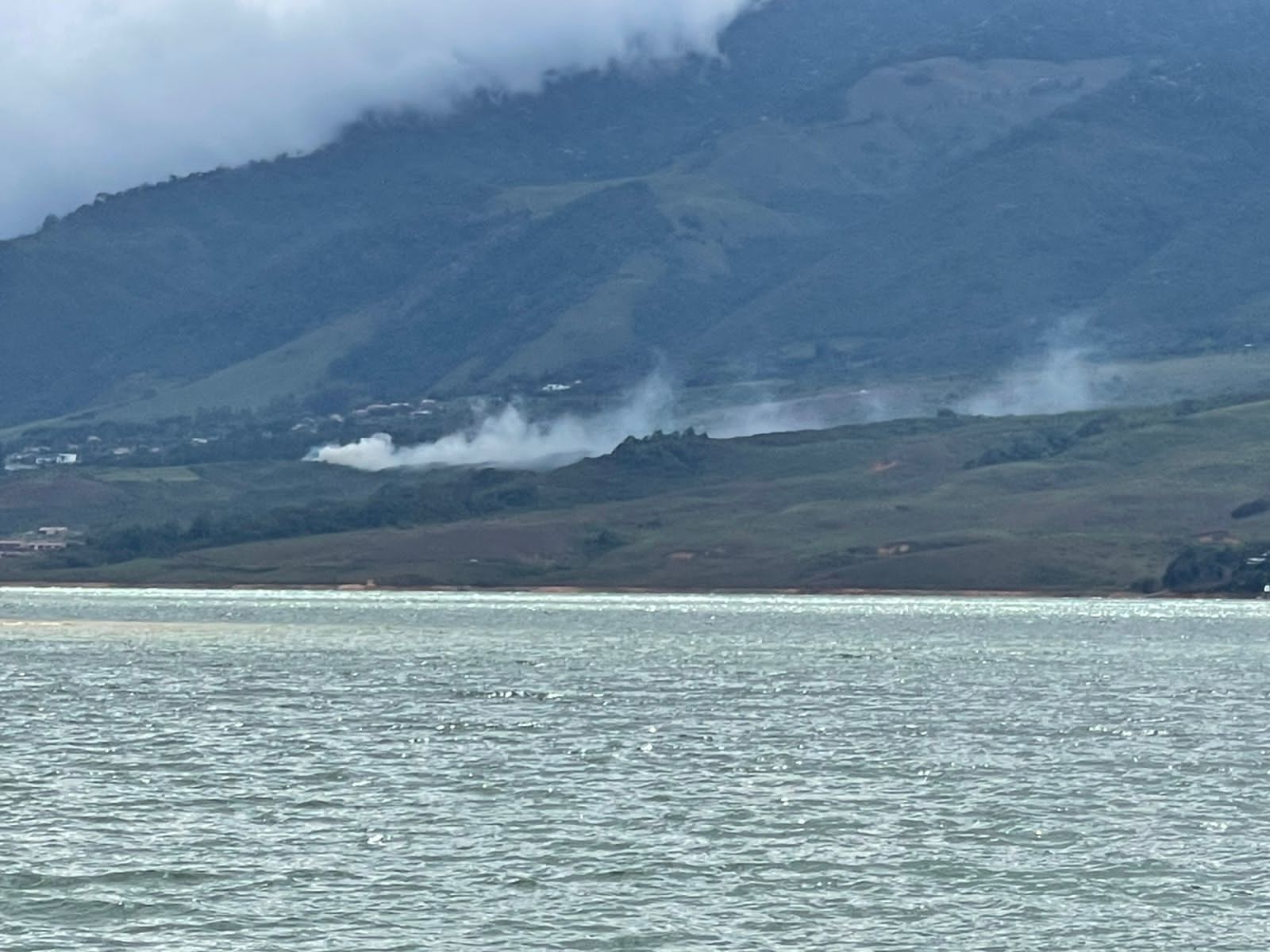Small waves on the lake, with mist over the mountain